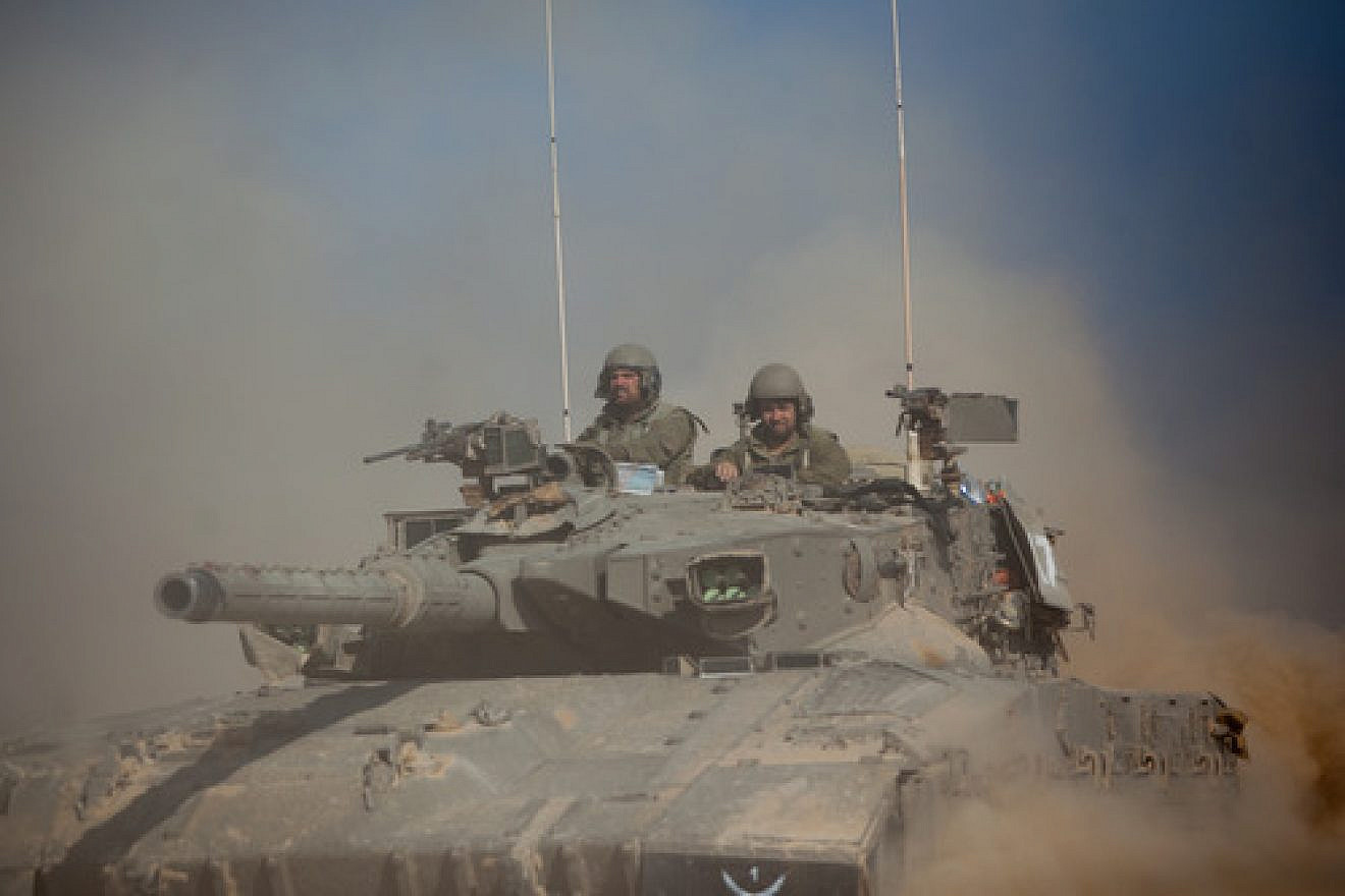 An Israel Defense Forces tank crosses through a field near the border with Gaza in southern Israel on July 21, 2014, two weeks into “Operation Protective Edge.” Photo by Yonatan Sindel/Flash90.