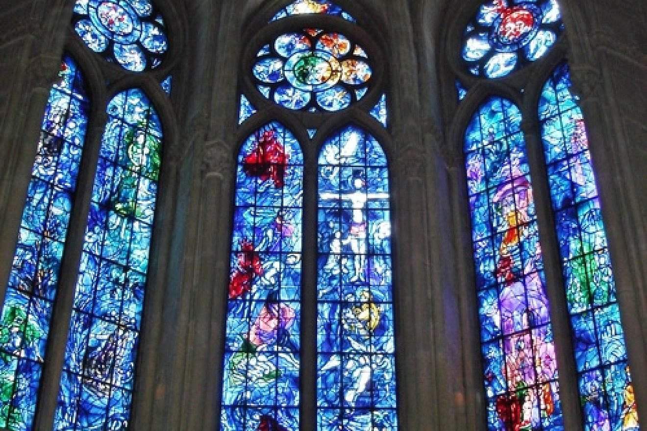 Stained-glass windows in the axial chapel of Reims Cathedral in France, designed by Marc Chagall and made by Charles Marq in 1974. Credit: Peter Lucas via Wikimedia Commons.