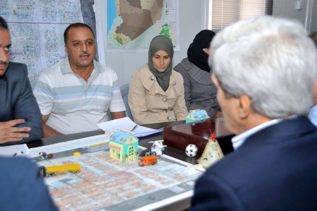 A Syrian civil war refugee speaks to U.S. Secretary of State John Kerry as he visits the Za'atri Refugee Camp in Jordan on July 18, 2013. Credit: U.S. State Department.