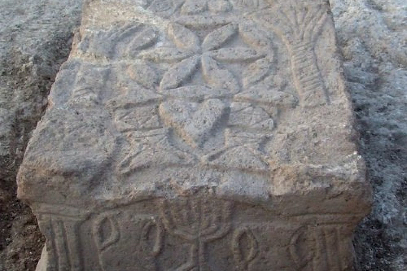 The Magdala Stone and its iconic menorah depiction. Credit: Magdala Center and Israel Antiquities Authority.