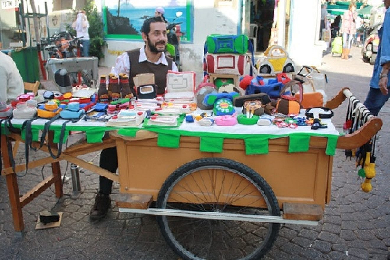 Amnon Lipkin, a fabric artist who runs a business called Pashut, at Tel Aviv’s Nachalat Binyamin Art & Craft Fair. Credit: Courtesy Amnon Lipkin.