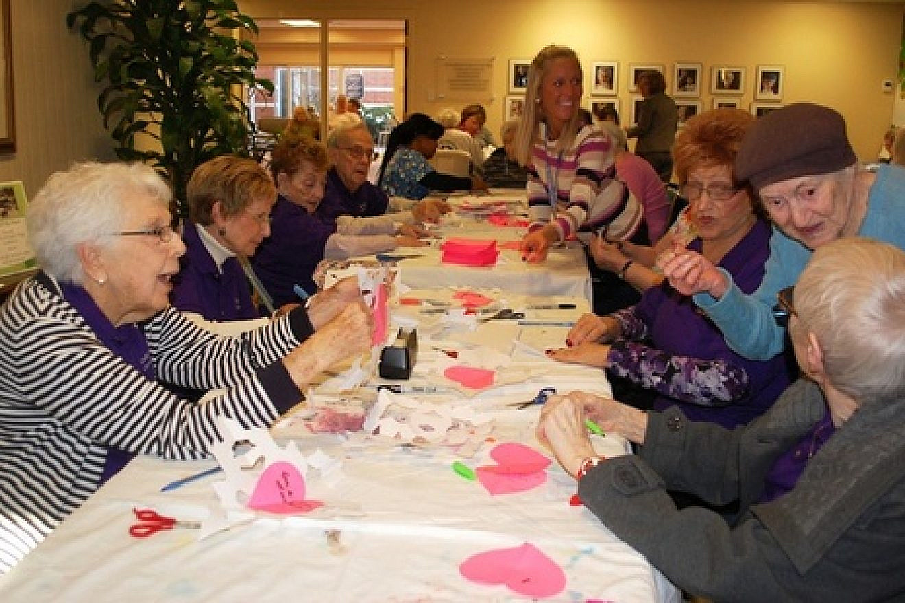 "Chesed Corps" volunteers of the Cedar Village Retirement Community in Mason, Ohio, create paper snowflakes in January 2013 to send to Sandy Hook Elementary School students in Connecticut. The snowflakes helped to welcome the students back to school after the shootings. Credit: Cedar Village Retirement Community.