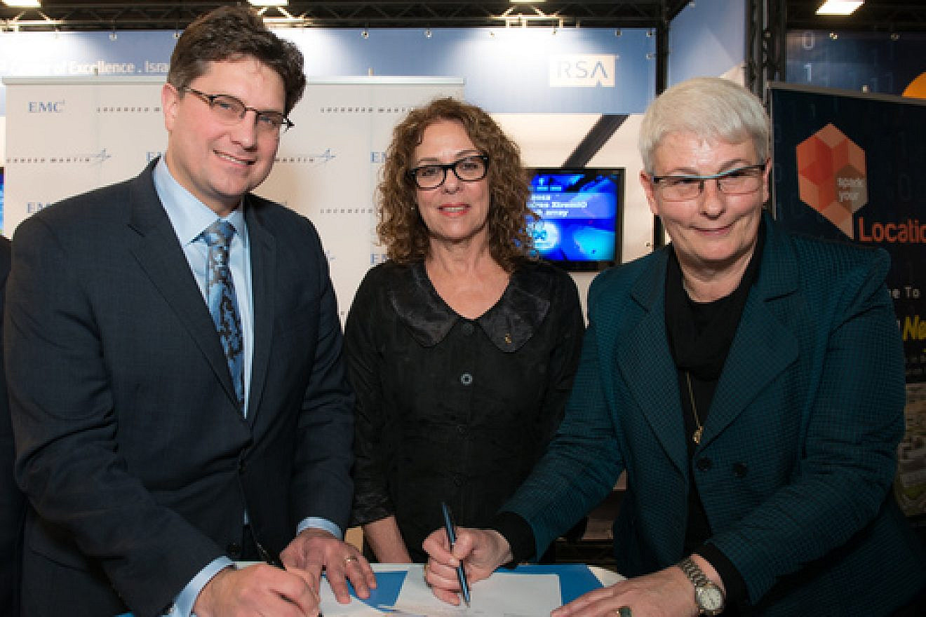 Lockheed Martin and EMC executives sign an agreement to fund collaborative research at the new CyberSpark national cyber-security complex in Beersheva as Ben-Gurion University of the Negev President Professor Rivka Carmi looks on. Credit: Courtesy.