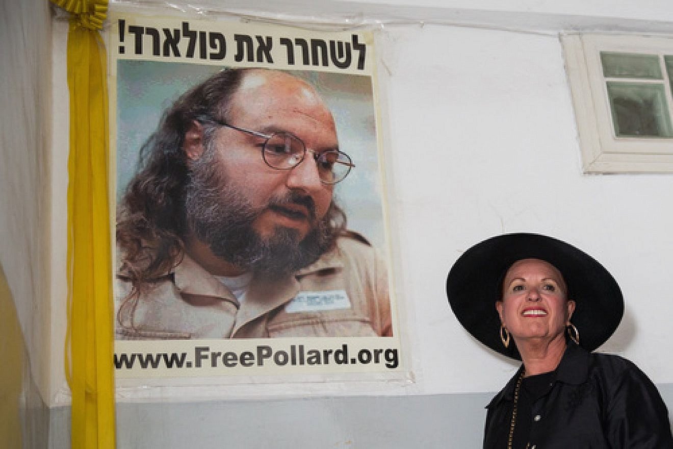 Esther Pollard walks past a poster of her husband, Jonathan Pollard, before speaking to reporters outside of her Jerusalem home on July 29, the day after it was announced that Jonathan, jailed for nearly 30 years over giving Israel classified information on America, will be released in November 2015. Photo by Flash90.
