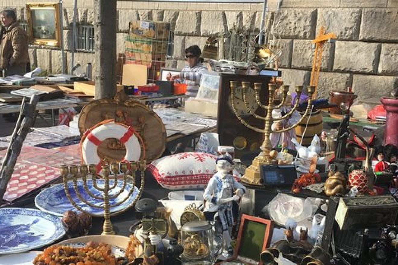 Two Hanukkah menorahs are pictured among other antiques at a flea market in Berlin. Credit: Orit Arfa.