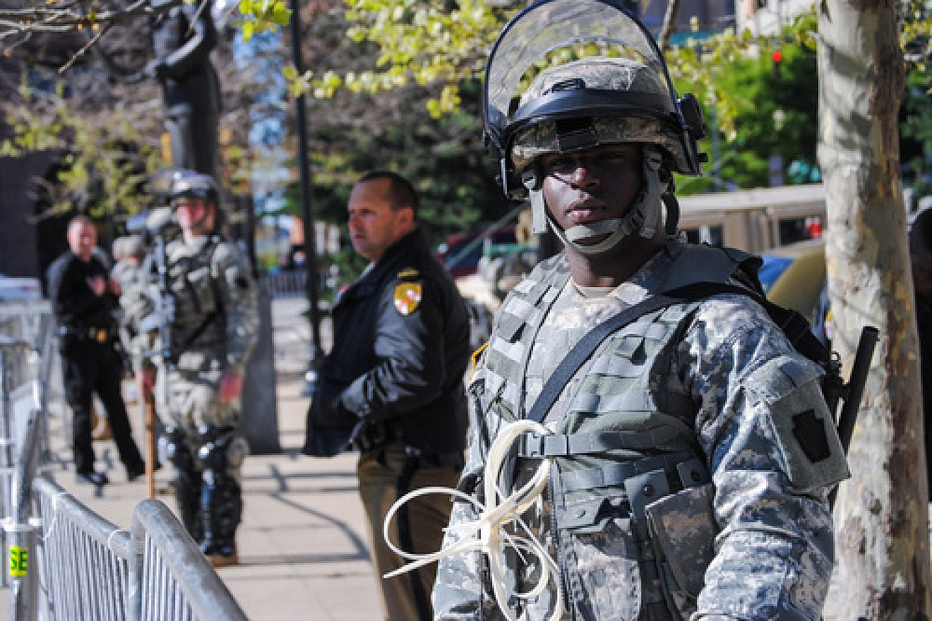 Click photo to download. Caption: A Maryland National Guard soldier keeps watch in front of Baltimore City Hall on April 28 to help deter violence in that area. Credit: Staff Sgt. Ron Lee, 29th Mobile Public Affairs Detachment.