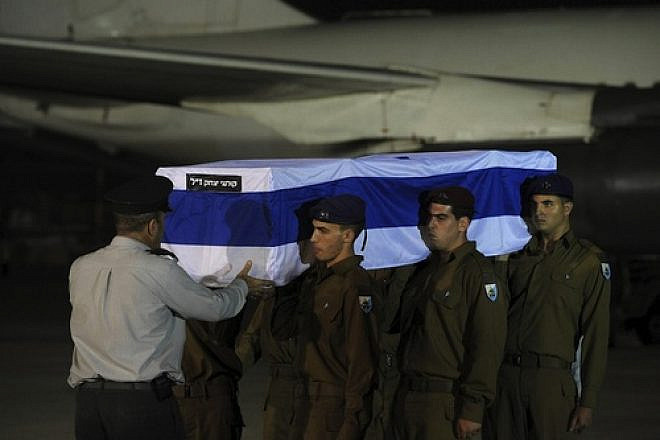 Israeli soldiers carry the five coffins holding Israeli citizens Itzik Colangi, 28, Amir Menashe, 28, Maor Harosh, 25, Elior Price, 26, and Kochava Shriki, 44, killed in a suicide bombing attack in Bulgaria July 18, at a cermony after the bodies arrived at Ben-Gurion Airport early Friday morning, July 20. Credit: Amos Ben Gershom/GPO/FLASH90.