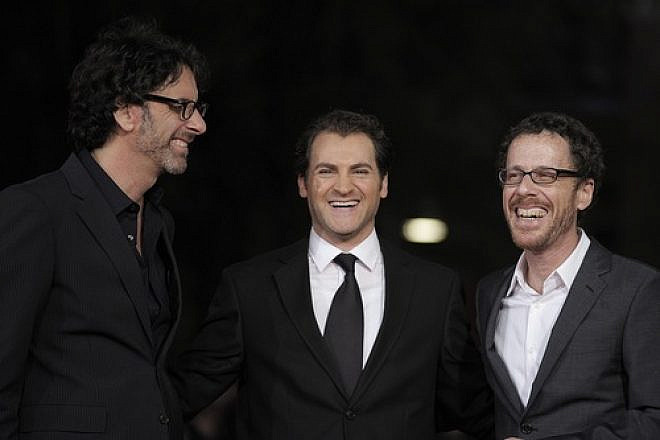 U.S. directors and producers Joel (left) and Ethan Coen pose for photographs with US actor and cast member Michael Stuhlbarg on the red carpet as they arrive at the screening of their film, "A Serious Man" during the 4th annual Rome Film Festival in Italy on Oct. 22, 2009. Credit: EPA/Guida Montani.