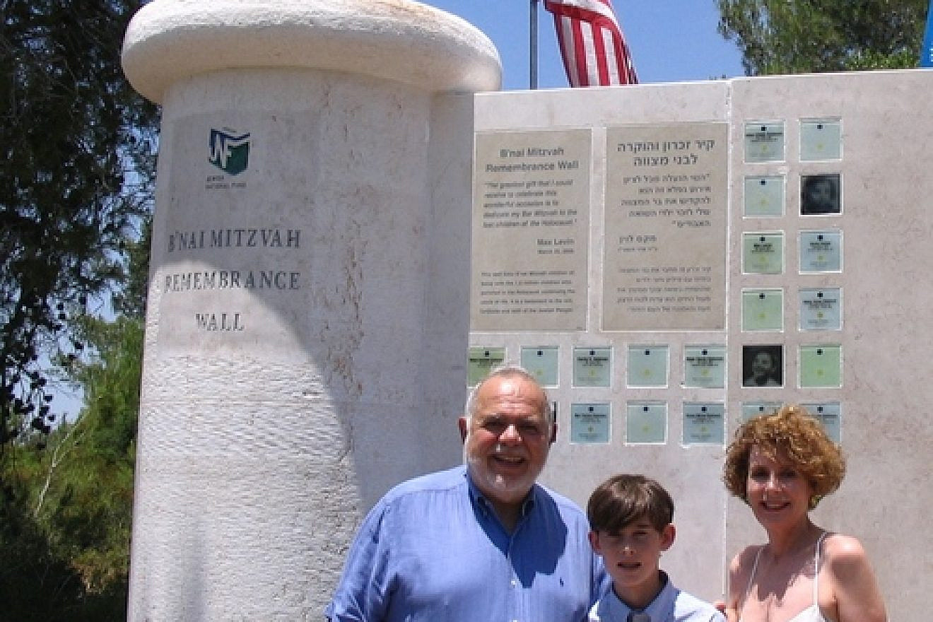 Max Levin with his parents Judy and Bud in front of the B’nai Mitzvah Remembrance Wall, located in the Jerusalem hills near Beit Shemesh. Credit: Jewish National Fund.