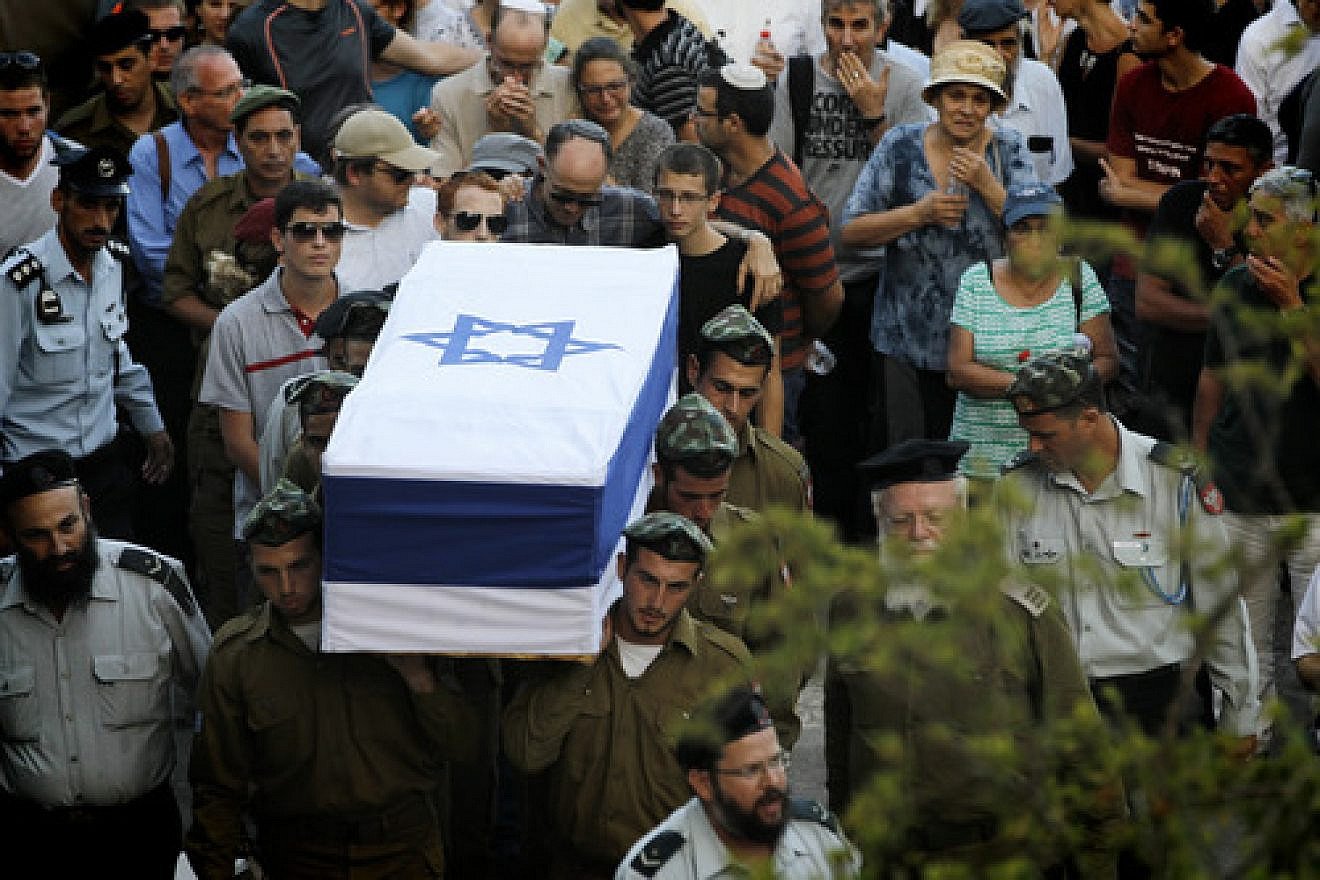 Friends and relatives mourn at the funeral of IDF Sgt. Barkey Ishai Shor on Mount Herzl in Jerusalem on July 29, 2014. Shor was one of 66 Israeli soldiers killed during last summer's war with Hamas. Credit: Miriam Alster/Flash90.