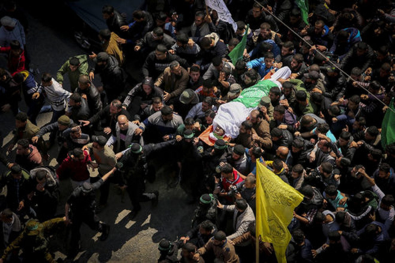 Masked terrorists from Hamas’s Izz ad-Din al-Qassam Brigades carry the body of slain terror commander Mazen Faqha during his funeral in Gaza City Saturday, March 25. Credit: Abed Rahim Khatib/Flash90.