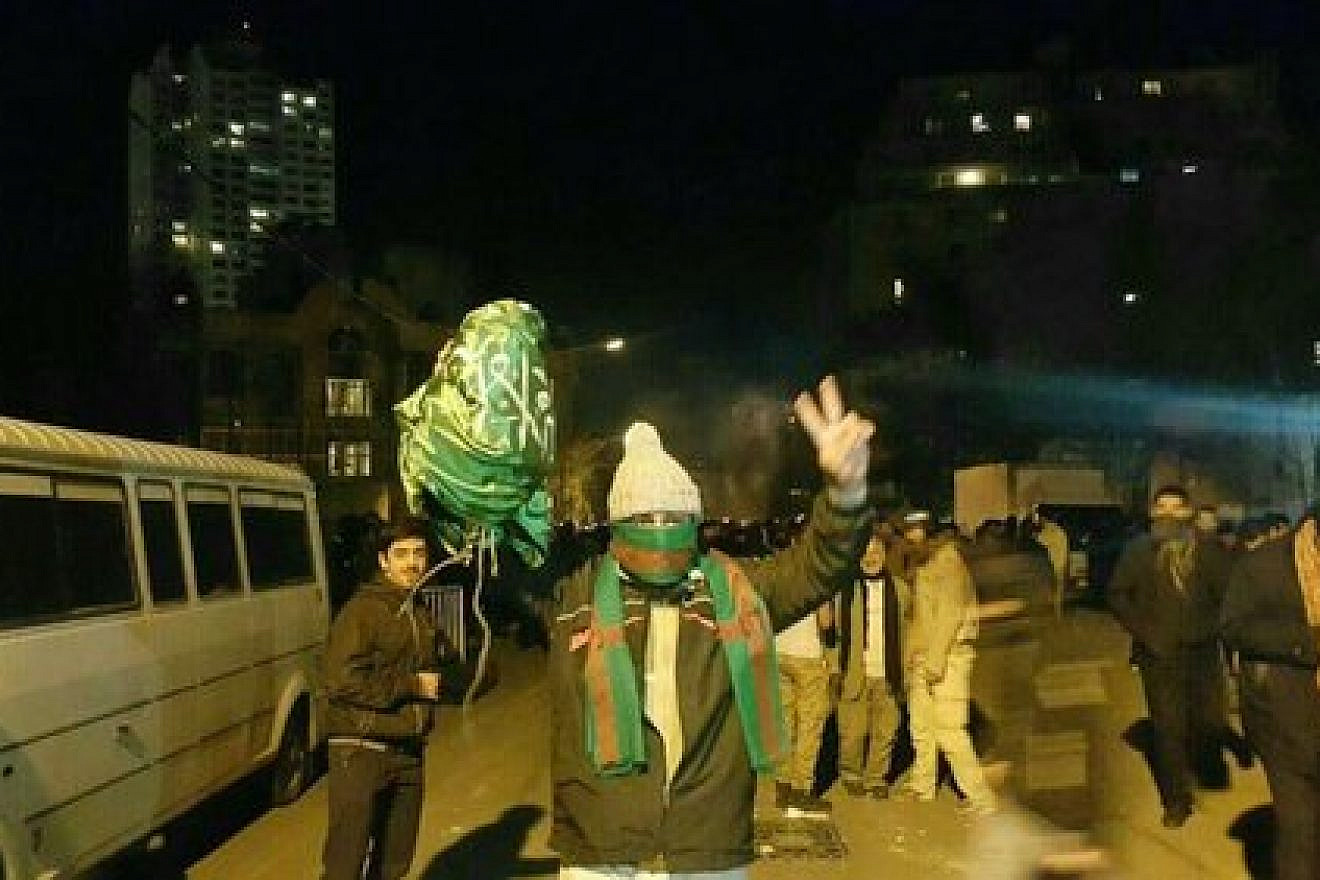 Protesters bring down the Saudi flag at the Arab nation's embassy in Tehran, Iran, on Jan. 2, 2018. Credit: Sobhan Hassanvand via Twitter.
