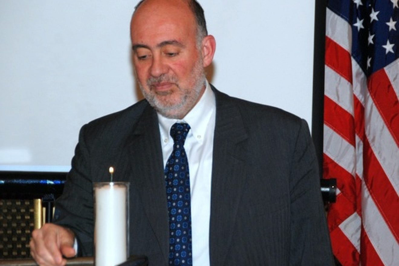 Click photo to download. Caption: On Monday night in New York, Ron Prosor, Israel’s Permanent Representative to the United Nations, lights a candle at a memorial for the 20th anniversary of the Israeli embassy bombing in Buenos Aires, Argentina. Credit: Maxine Dovere.