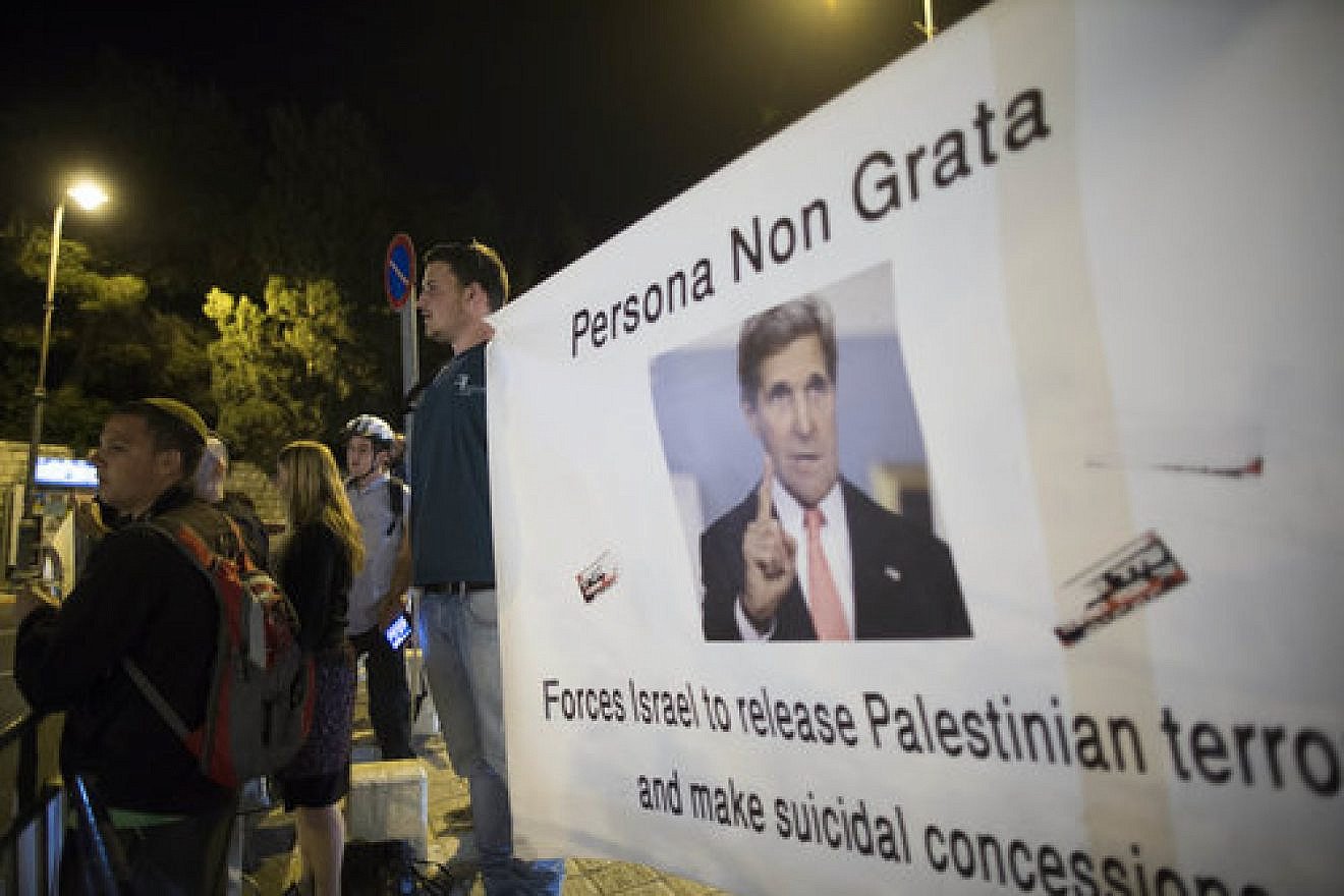 Israeli protesters hold banners when U.S. Secretary of State John Kerry was in Jerusalem for peace talks March 31, 2014. Credit: Yonatan Sindel/Flash90.