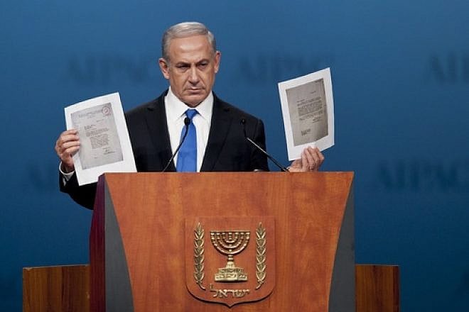 During his Monday night speech at the AIPAC policy conference, Prime Minister Benjamin Netanyahu holds up a copy of letters from 1944, in which the World Jewish Congress had implored the American government to bomb Auschwitz. Credit: EPA/PETE MAROVICH.
