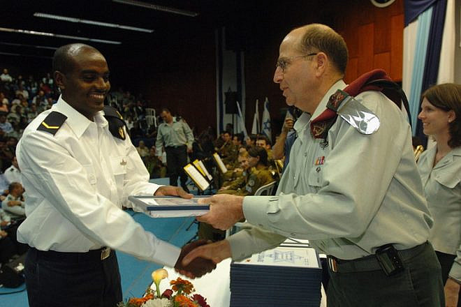 Click photo to download. Caption: Moshe Ya'alon, now Israel's vice prime minister and former IDF chief of staff, presents an award of excellence to an Israeli naval officer. Credit: IDF Spokesperon.