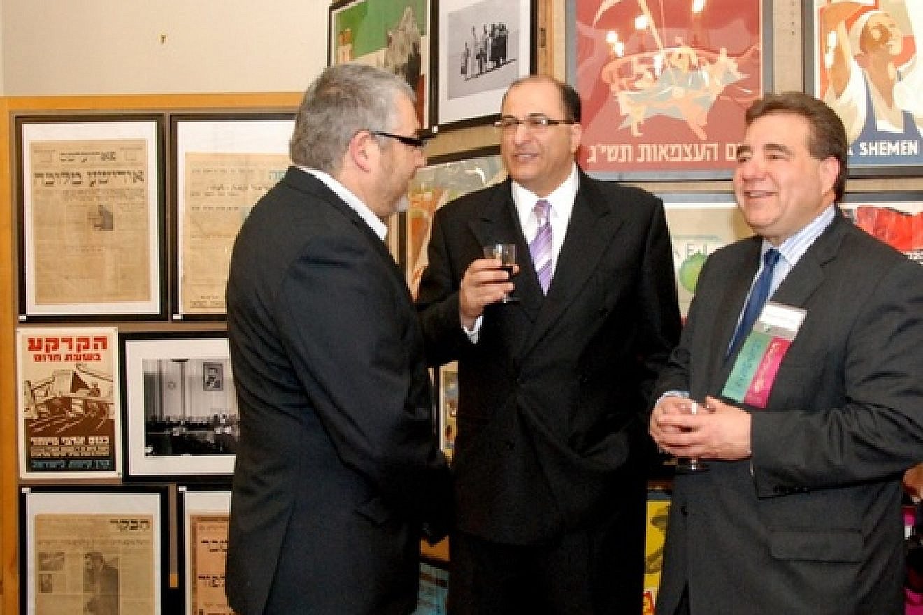 Aharon Farkash (left), director of the Farkash Gallery in Israel, joins Israel's Consul General in New York Ido Aharoni and Jewish National Fund CEO Russel F. Robinson March 28 at the opening of the "Made in Israel 2012" exhibit (which can be seen in the background). Credit: Maxine Dovere.