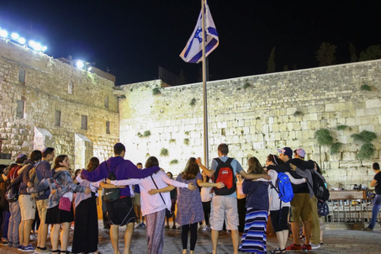 Participants of Ramah's Israel summer-camp experience stand arm in arm at the Western Wall in Jerusalem. Credit: Ramah Commission.