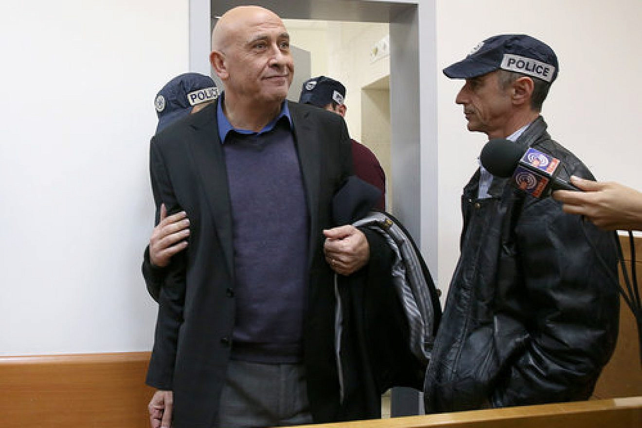 Basel Ghattas, an Arab member of the Israeli Knesset, is brought to the Rishon Lezion Magistrate's Court in central Israel Dec. 26, 2016, over allegations that he smuggled cell phones to Palestinian security prisoners. Credit: Koko/POOL/Flash90.