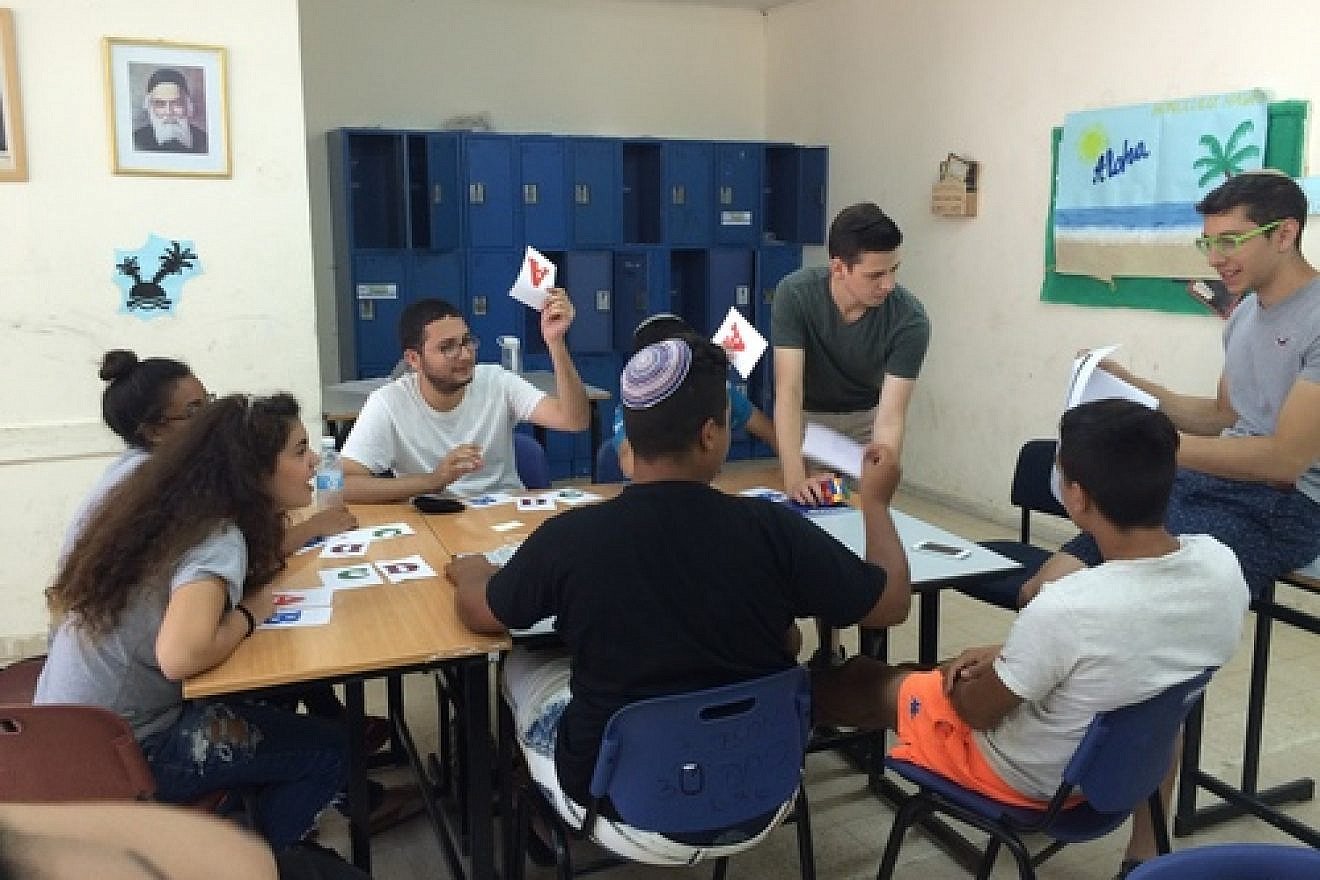 Zach Katz (second from right, standing) of Bergenfield, N.J., and Elan Rotenberg (far right) of Baltimore, Md., run an English class for Counterpoint Israel campers in Kiryat Gat. Credit: Courtesy.