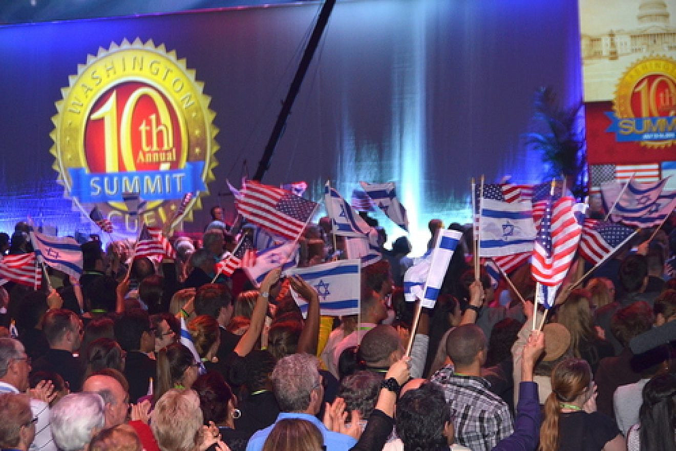 Attendees of the 10th Christians United for Israel Washington Summit wave Israeli and American flags on Monday night. The next morning brought an announcement of a nuclear deal between Iran and world powers. Credit: Maxine Dovere.