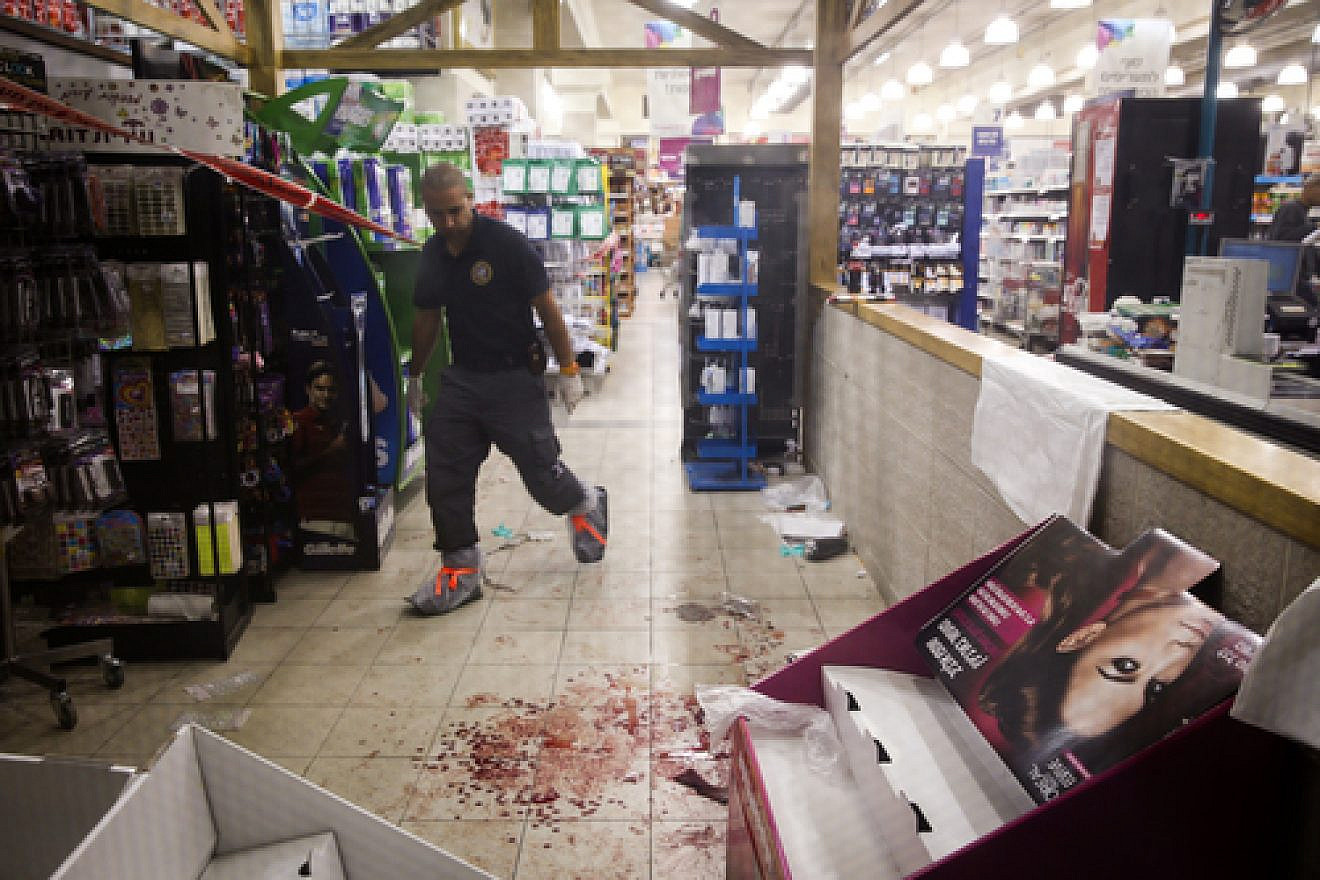 Israeli security and police forces are seen at the Rami Levy supermarket in the Mishor Adumim industrial zone, where a Palestinian man stabbed two people and was later shot by a security guard on Dec. 4, 2014. Police are treating the incident as a terror attack. Credit: Nati Shohat/Flash90.