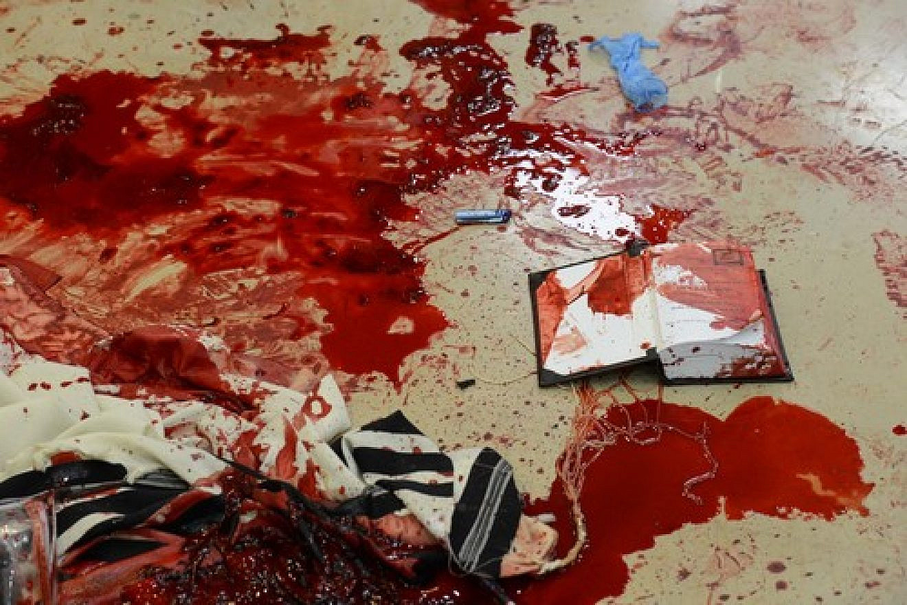 Blood on prayer shawls and a siddur inside the Kehilat Bnei Torah synagogue in Jerusalem following the terrorist attack that took place there on Nov. 18, 2014. Cerdit: Kobi Gideon/GPO/Flash90.