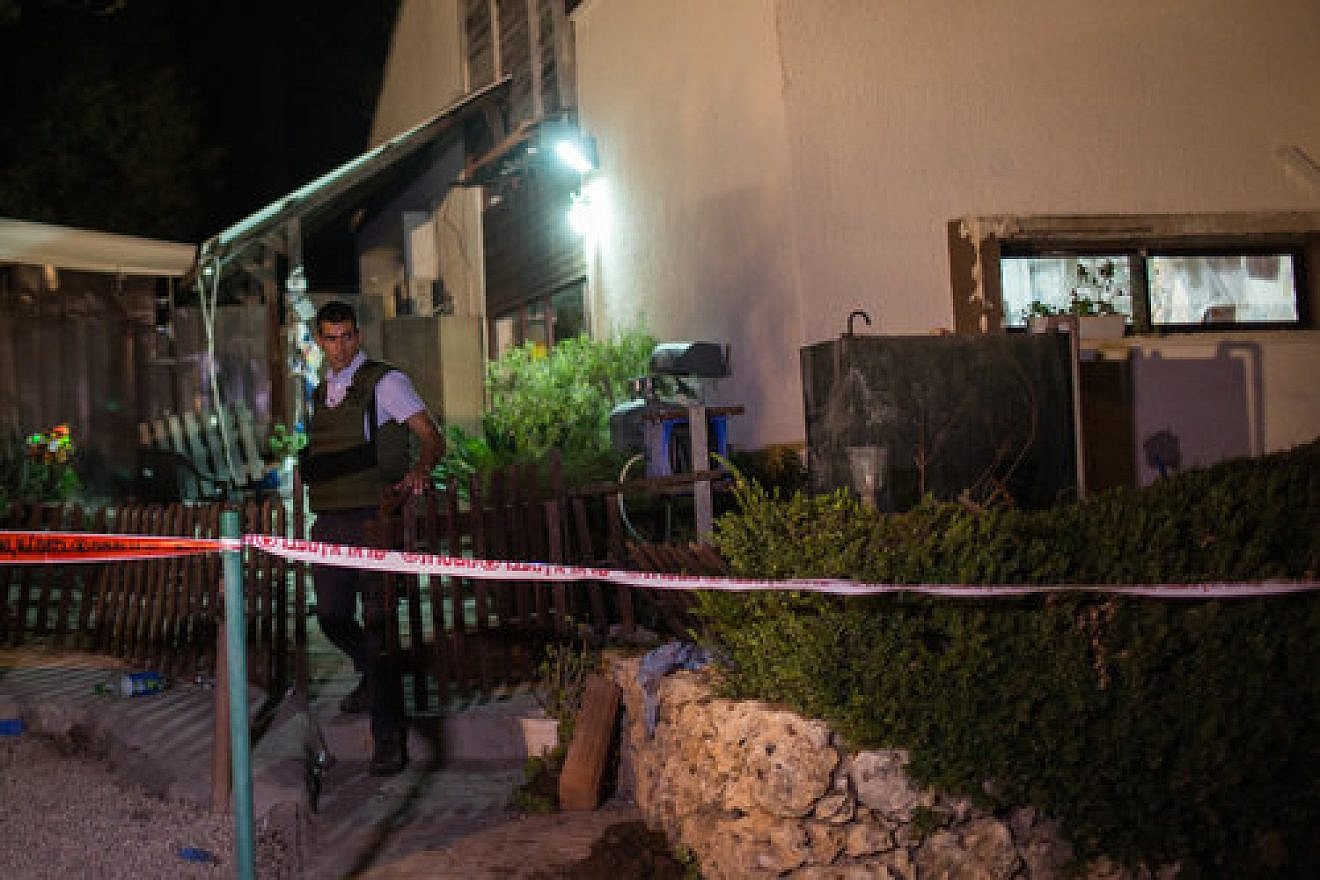 An Israeli security officer outside the home in Halamish where a Palestinian terrorist killed three members of an Israeli family July 21. Credit: Hadas Parush/Flash90.
