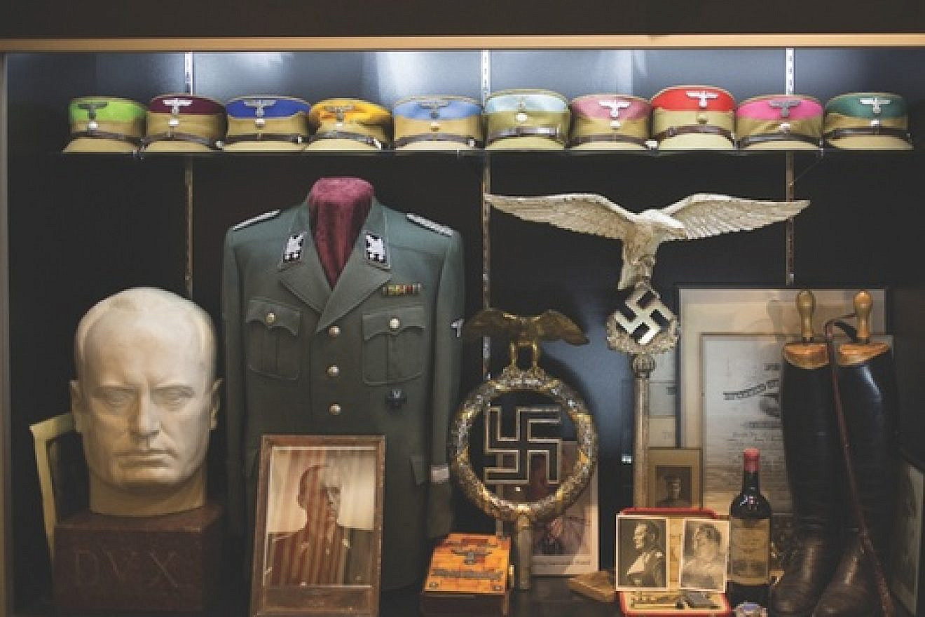 Inside the Solana Beach, Calif., warehouse of Craig Gottlieb. Lining the walls of the warehouse are Nazi military uniforms, iron crosses, swastika flags, and German military propaganda. Credit: Daisy Varley.