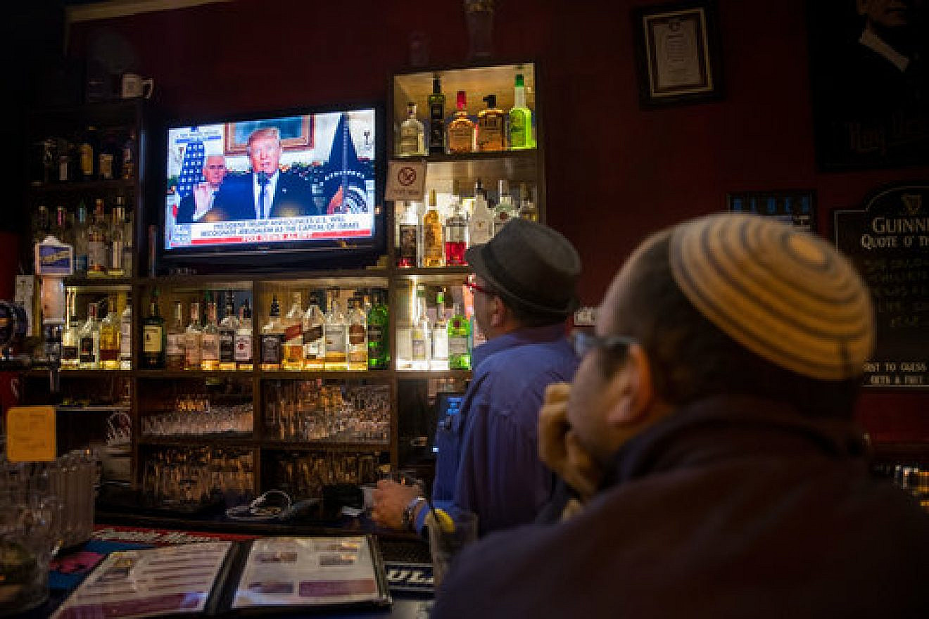 Israelis at a pub in Jerusalem watch a broadcast of President Donald Trump’s Dec. 6 announcement on U.S. policy towards Israel’s capital. Credit: Yonatan Sindel/Flash90.