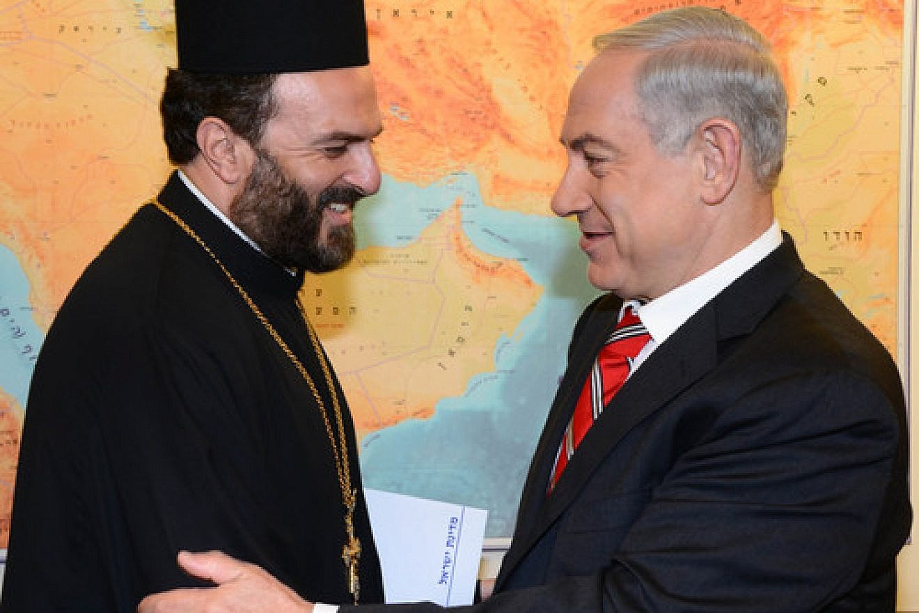 Click photo to download. Caption: Israel's Prime Minister Benjamin Netanyahu (right) meets with Greek Orthodox priest Father Gabriel Nadaf in Jerusalem, on August 5, 2013. Nadaf is a vocal supporter of Christian recruitment into the Israel Defense Forces. Credit: Moshe Milner/GPO/FLASH90.