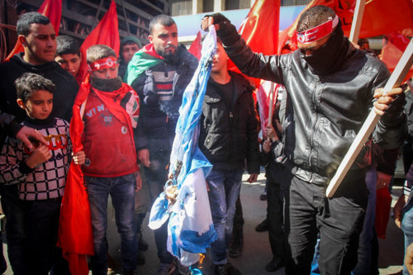 Palestinian protesters burn an Israeli flag during a rally marking the 48th anniversary of the “Democratic Front for the Liberation of Palestine” in the West Bank city of Nablus, Feb. 18, 2016. Credit: Nasser Ishtayeh/Flash90.