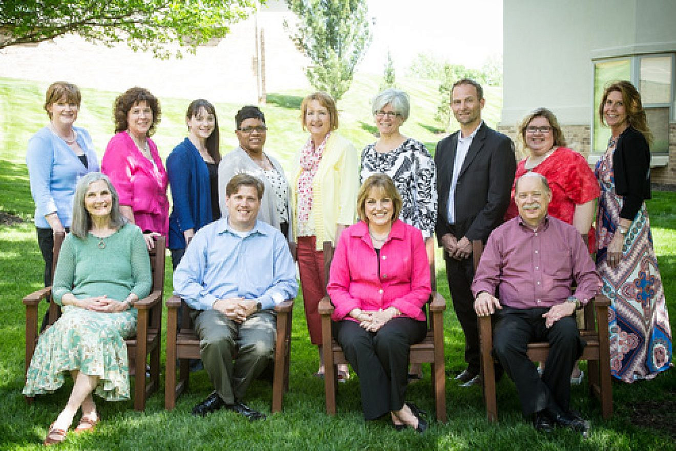 The management team at Village Shalom in Overland Park, Kan. Back row (left to right): Sally Beyers (director of development); Jill Allin (director of marketing); Nicole Anthony (director of finance); Tami Middleton (director of human resources); Lora Baugher (director of information technology); Eileen Miller (director of resident services); Michael Matson (director of dining services); Paula Carpenter (director of social services); Jill Craft (director of assisted living). Front row (left to right): Marion Wilson (director of admissions); Matt Lewis (president and CEO); Karin McCrary (COO); Lee Kortemeyer (director of facilities). Credit: Village Shalom.