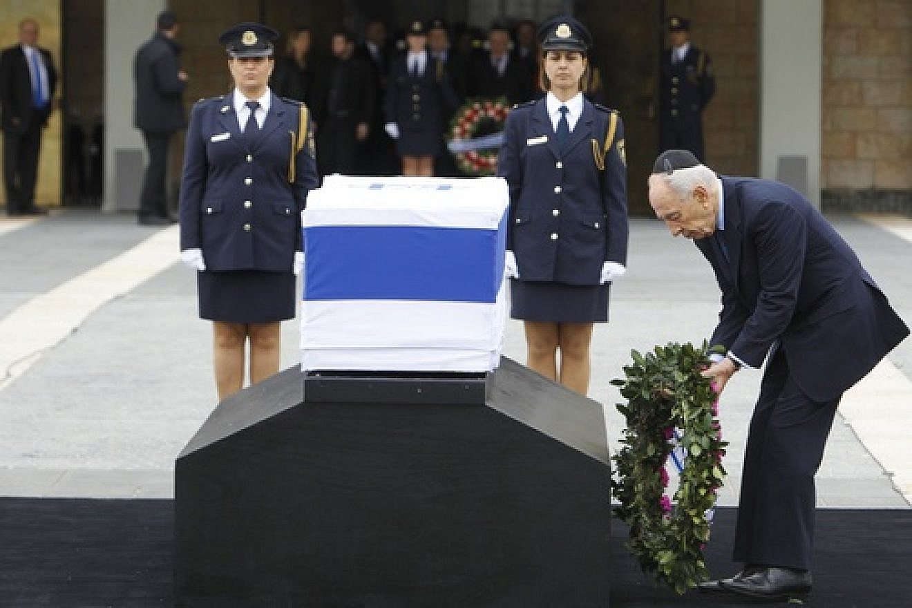 Israeli President Shimon Peres pays his respects at the coffin holding former Israeli Prime Minister Ariel Sharon, laid outside the Knesset. Sharon passed away Jan. 11. Credit: Miriam Alster/Flash90.