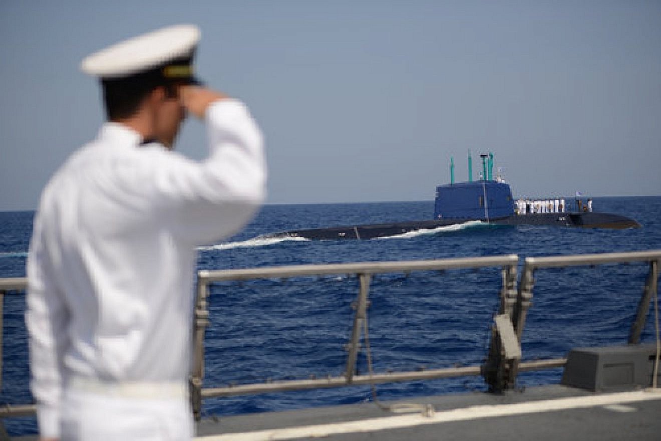 An Israeli Navy member gives a salute and looks on in September 2014 while a memorial ceremony is held at sea—from the navy's INS Tanin submarine—for the personnel of the INS Dakar, which sank off the coast of Haifa in 1968. Credit: Gadi Yampel/IDF Spokesperson/Flash90.