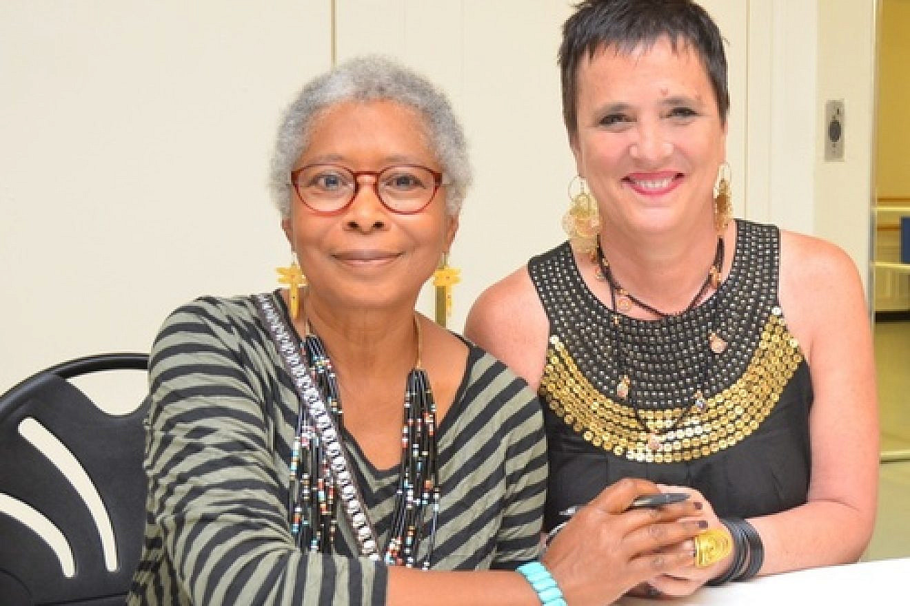 Author Alice Walker, an anti-Israel activist, and playwright Eve Ensler clasp hands at the 92nd Street Y in New York City on the night they appeared together in dialogue, May 30, 2013. JCC Watch is calling for a halt in donations to the UJA-Federation of New York over UJA funding of the Y, which besides for Walker invited anti-Israel Pink Floyd band member Roger Waters this spring (an event that was ultimately canceled). Credit: Maxine Dovere.
