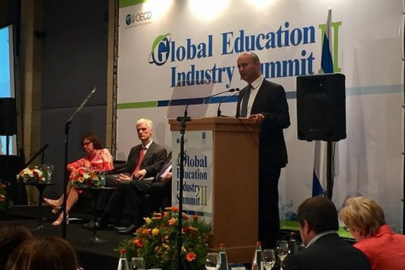 Israel's Minister of Education Naftali Bennett addresses the Organization for Economic Cooperation and Development summit in Jerusalem. Credit: Eliana Rudee.
