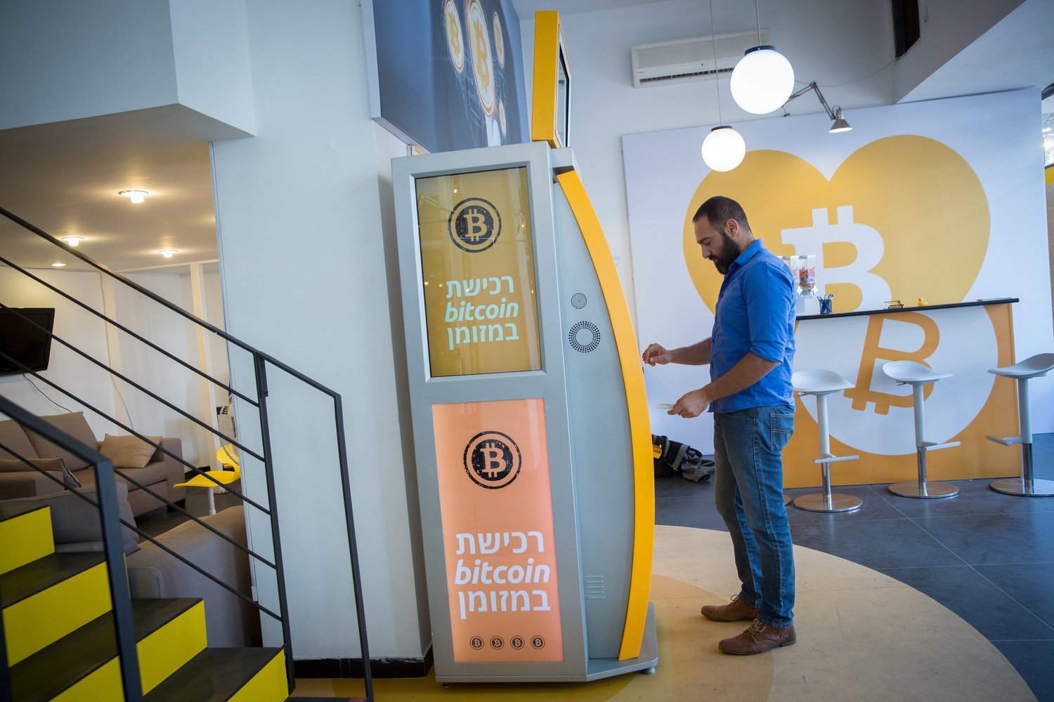 A man uses a bitcoin ATM machine at the Bitcoin Change center on Dizengoff Street in Tel Aviv on Nov. 5, 2023. Credit: Miriam Alster/Flash90.
