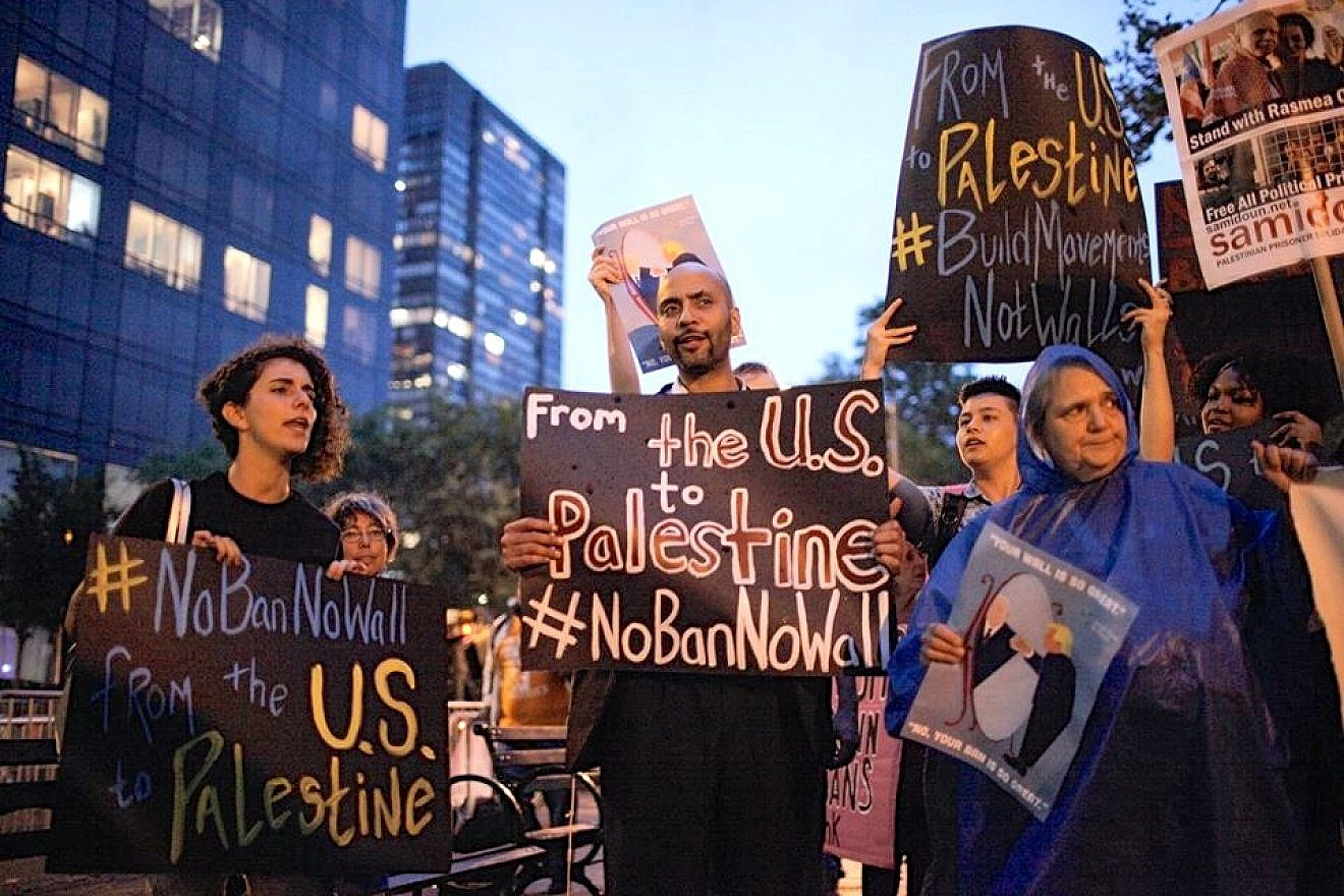 Protesters compare U.S. President Donald Trump's proposed U.S.-Mexico border wall to Israel's West Bank security fence at a Jewish Voice for Peace (JVP) demonstration in New York City last September. Credit: JVP via Facebook.