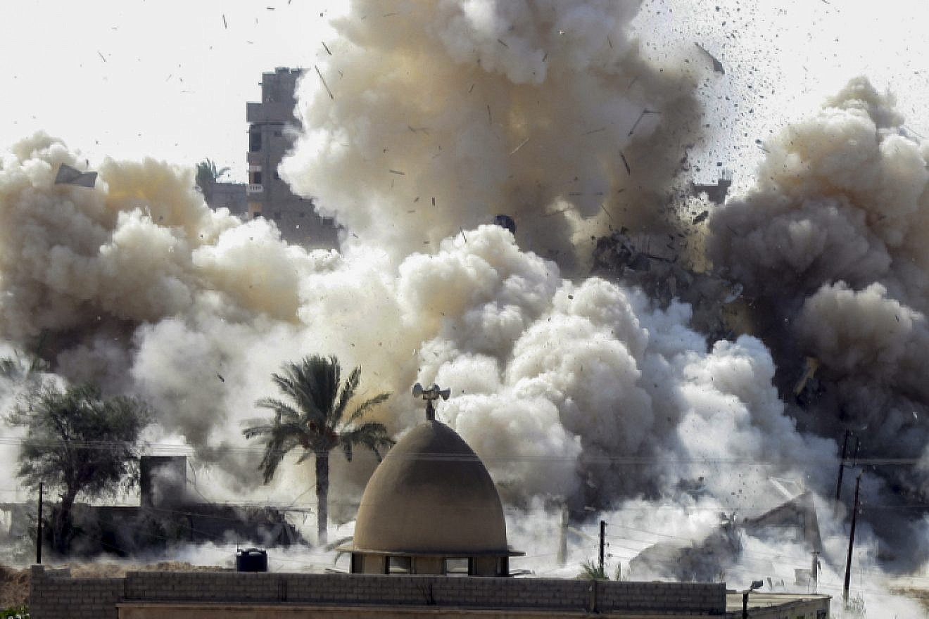 Smoke rises after a house was blown up during a military operation by Egyptian security forces in the Egyptian city of Rafah near the border with southern Gaza Strip, on Oct. 29, 2014. Photo by Abed Rahim Khatib/Flash90.