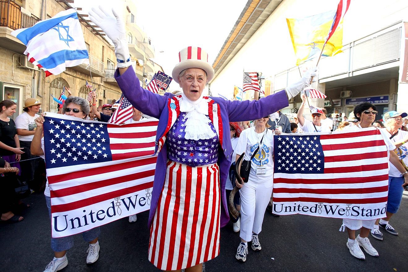 A Christian evangelical supporter waves during the annual parade in Jerusalem, marking the Jewish holiday of Sukkot (“The Feast of the Tabernacles”). Credit: Abir Sultan/Flash90.
