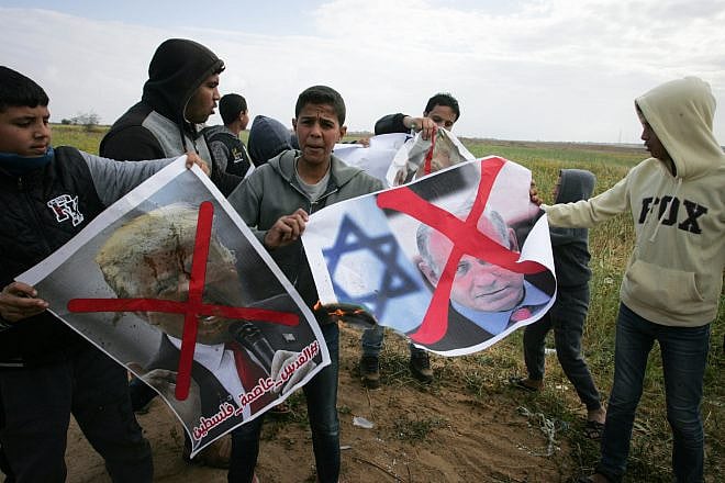 Palestinians demonstrate with posters marring the images of Israeli Prime Minister Benjamin Netanyahu and U.S. President Donald Trump during a protest near Khan Yunis in the southern Gaza Strip on March 30, 2018. Credit: Abed Rahim Khatib/Flash90
