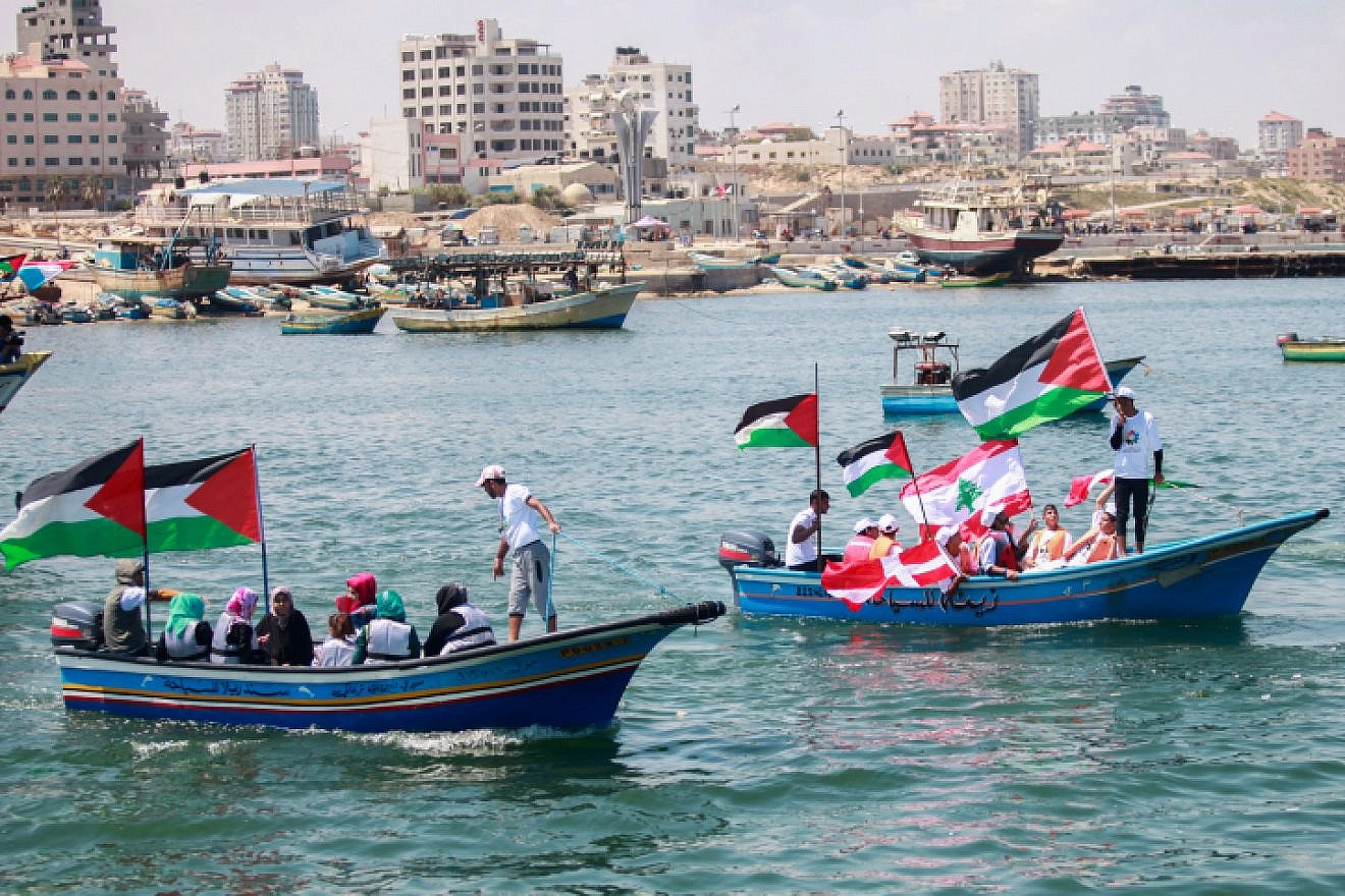 Palestinians hold flags during a rally at the seaport of Gaza City marking the fifth anniversary of the “Mavi Marmara” Gaza flotilla, May 31, 2015. Photo by Aaed Tayeh/Flash90.