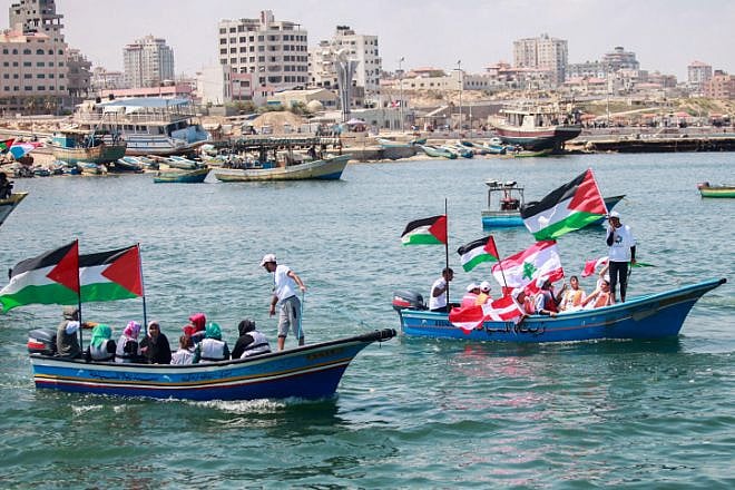 Palestinians hold flags during a rally at the seaport of Gaza City marking the fifth anniversary of the “Mavi Marmara” Gaza flotilla, May 31, 2015. Photo by Aaed Tayeh/Flash90.