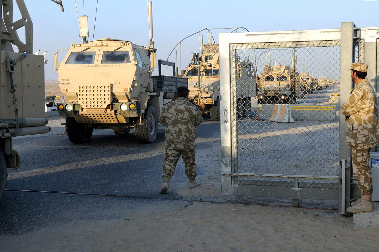 Kuwaiti soldiers look on as the last U.S. convoy crosses the border from Iraq into Kuwait as part of the pullout on Dec. 18, 2011. Credit: U.S. Army Photo by Cpl. Jordan Johnson.