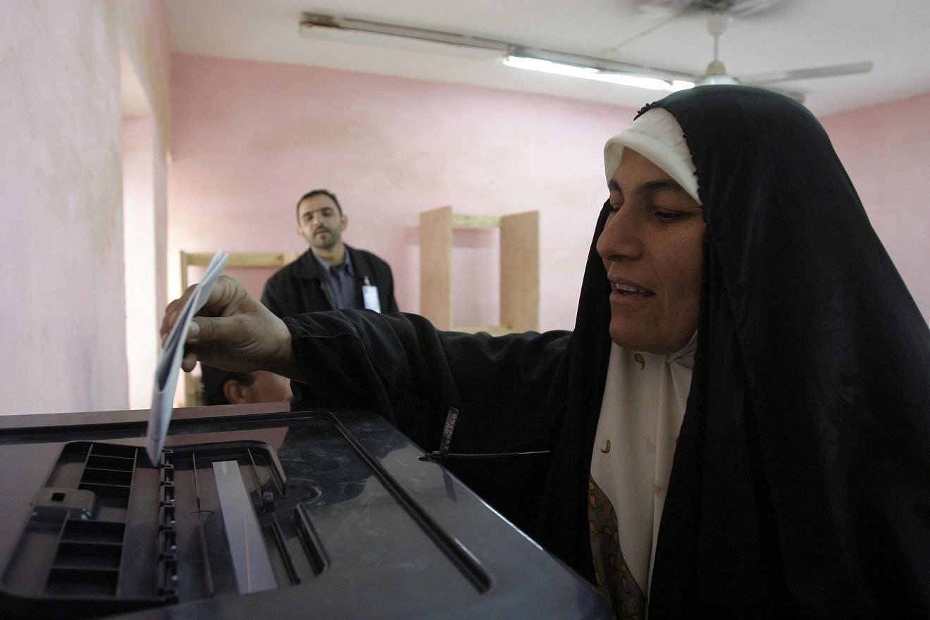 An Iraqi woman prepares to cast her voting ballot after filling it out at a polling site in Rawah, Iraq, during the country's first parliamentary election in December 2005. U.S. Marine Corps Photo by Lance Cpl. Shane S. Keller/Wikimedia Commons