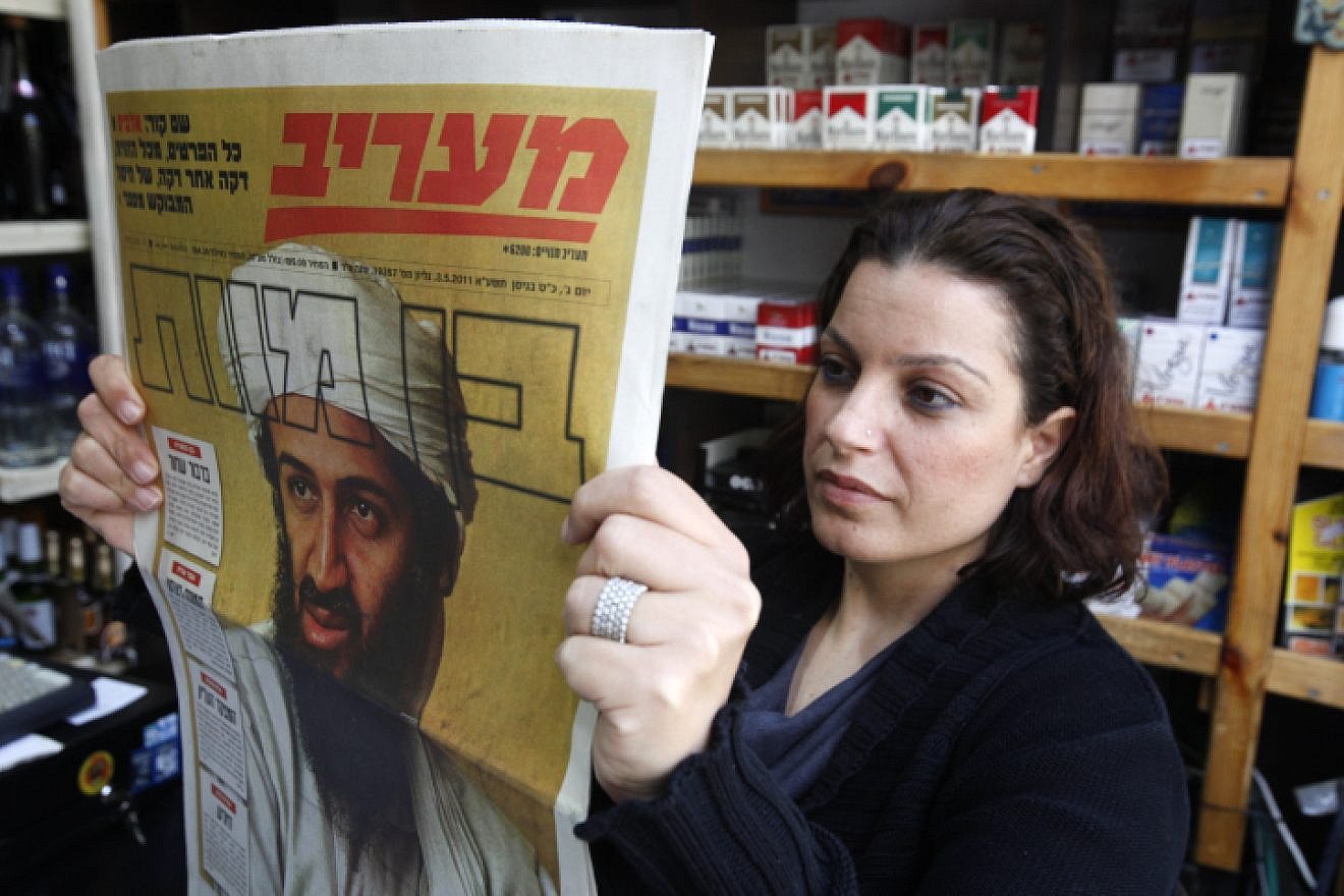 Israelis read about the death of Al-Qaeda leader Osama bin Laden in the news on May 3, 2011. Photo by Miriam Alster/Flash90