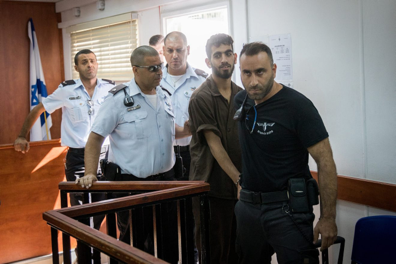 Omar Al-abed is brought to the courtroom for his trial at the Israel's Ofer military court near the West Bank city of Ramallah on Aug. 17, 2017. Alabed was detained after committing a deadly stabbing terror attack, killing Yosef Salomon (70), his daughter Haya (46) and son Elad (35) at their home in the Jewish settlement of Halamish. Photo by Yonatan Sindel/Flash90
