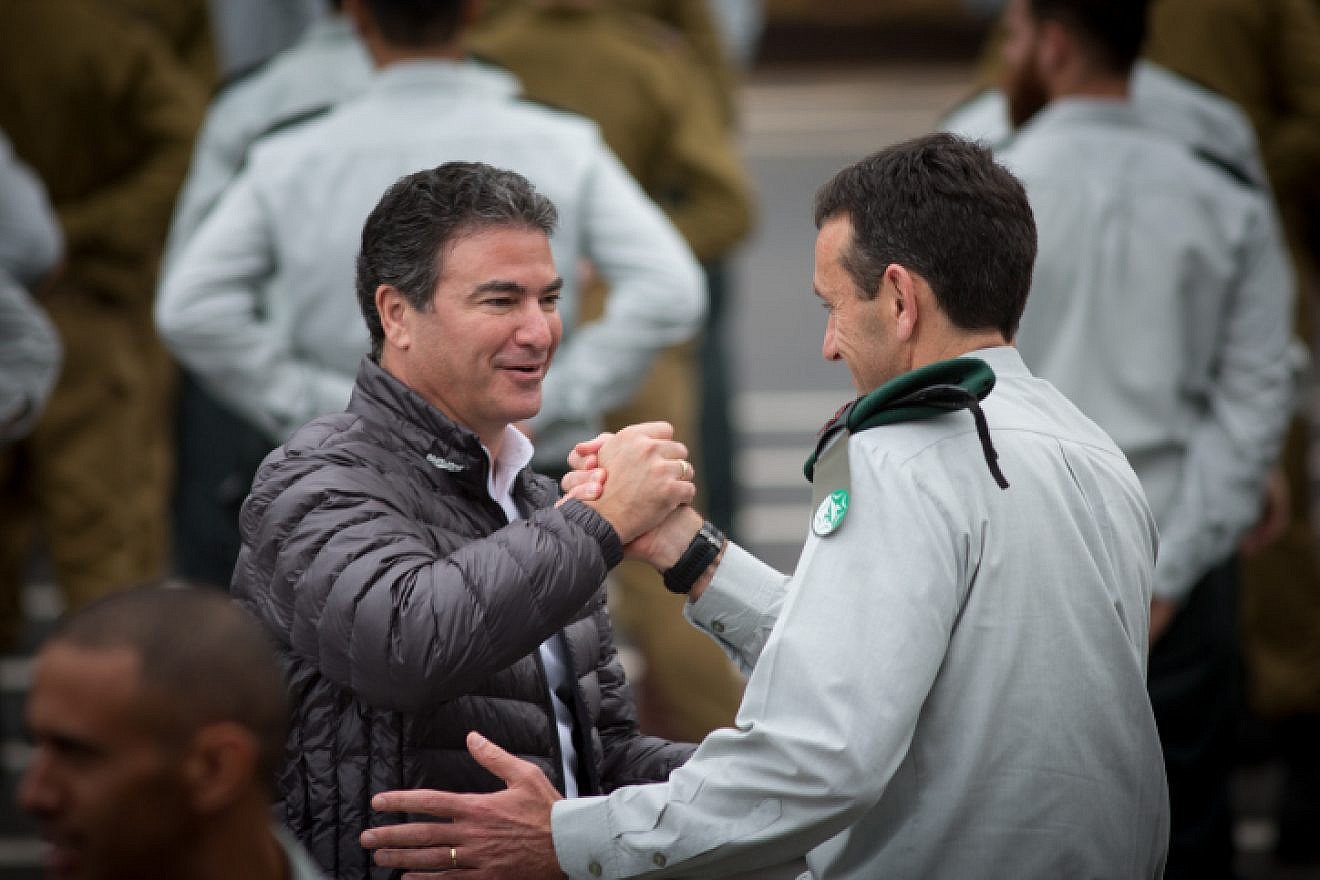 Director of the Mossad Yossi Cohen (left) greets outgoing Israel Defense Forces Chief of Intelligence Maj. Gen. Herzi Halevy at the Glilot military base near Tel Aviv, March 28, 2018. Photo by Miriam Alster/Flash90.