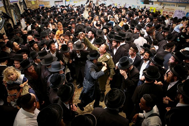 Jewish men celebrate the Jewish holiday of Lag B’Omer in the northern Israel town of Meron on May 3, 2018. Lag B’Omer commemorates the death of Rabbi Shimon bar Yochai, one of the most important sages in Jewish history, more than 1,800 years ago. Photo by David Cohen/Flash90.